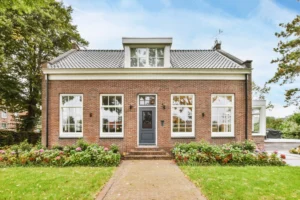 house with a variety of window styles in the Haverford area. Brick home with a large lawn